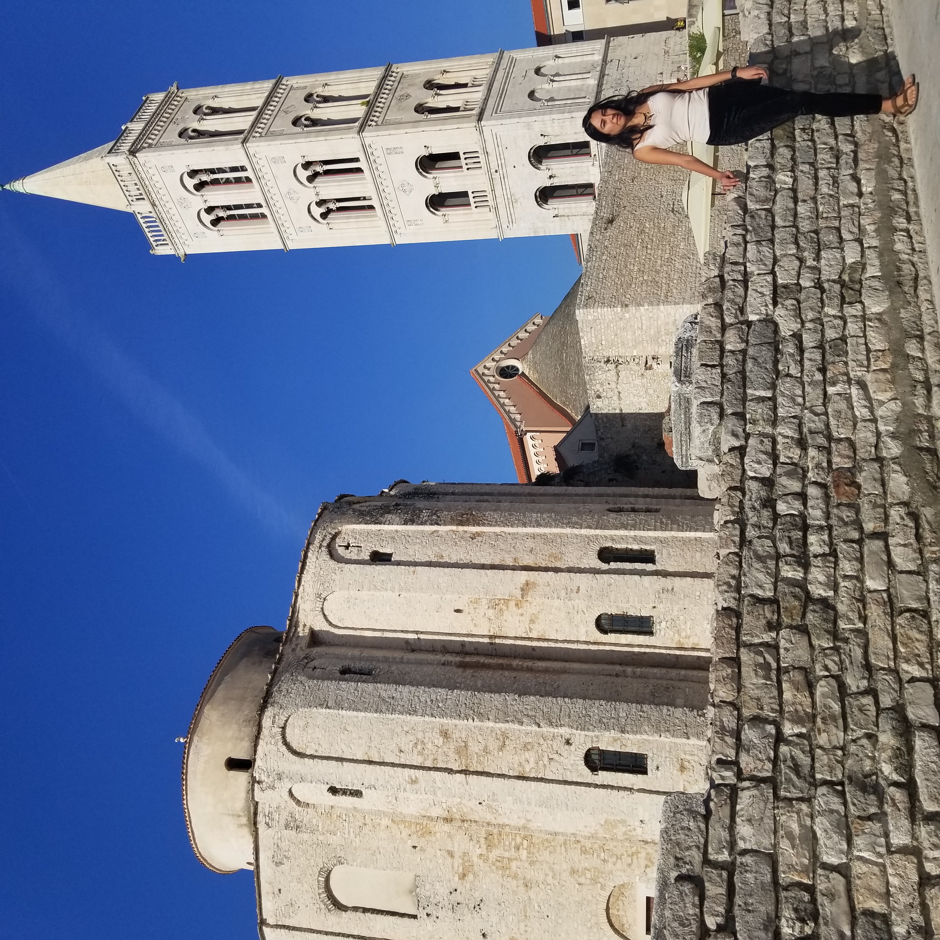 Zelzah poses in front of a building in Zadar, Croatia