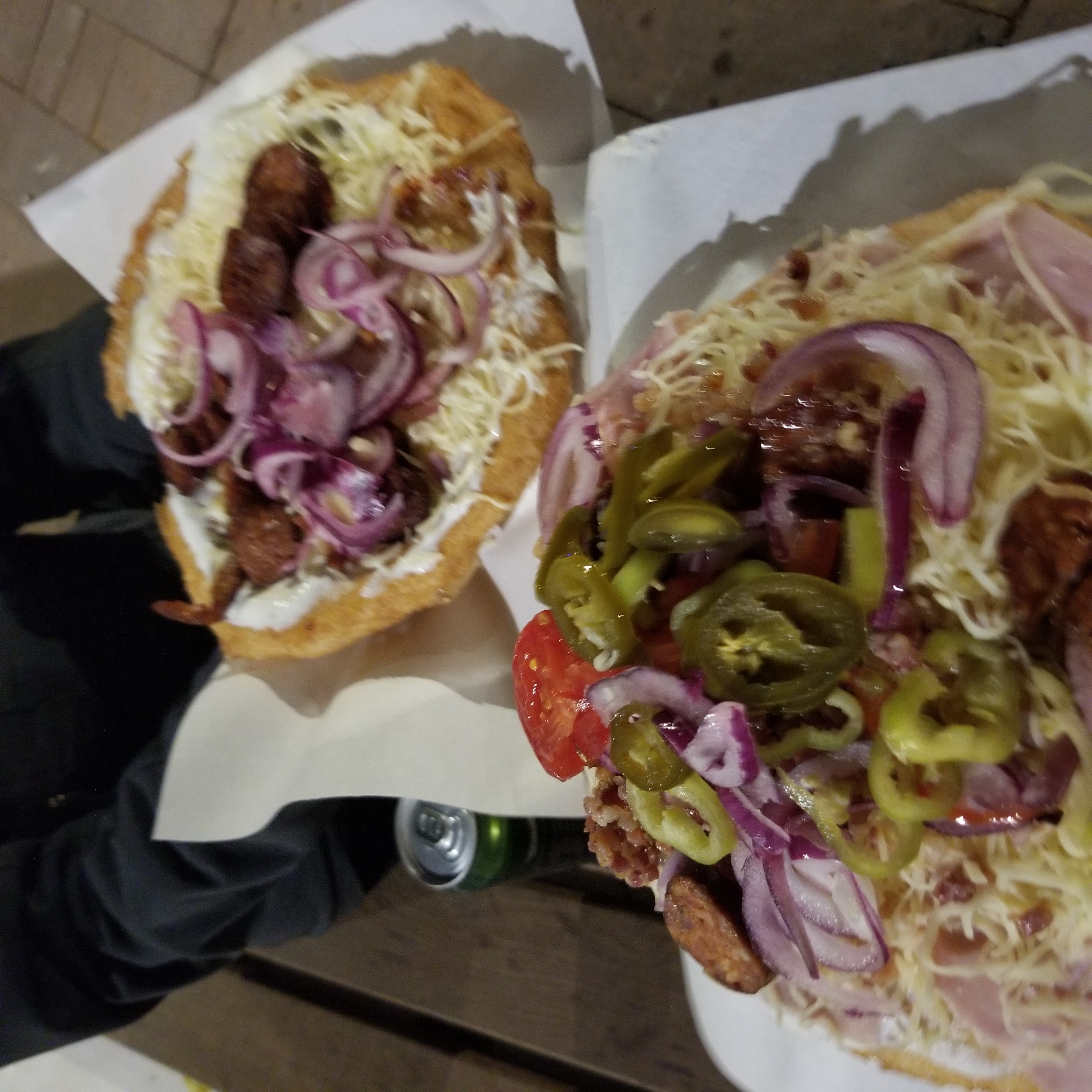 Langos, a traditional Hungarian "snack" of flatbread slathered in sour cream with cheese and other toppings piled on top. Each one of these "snacks" could make a hearty meal for two.