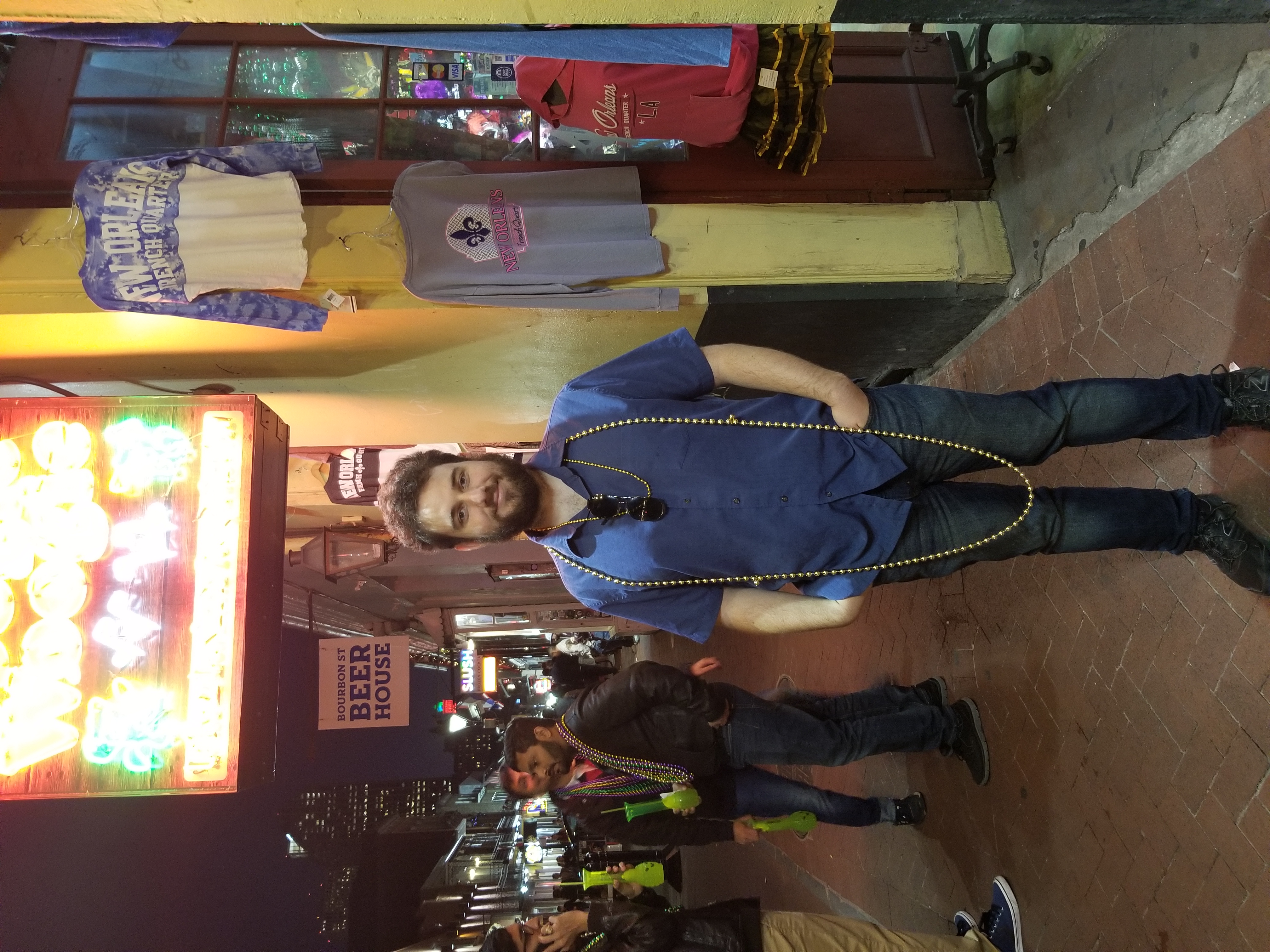 Walking down Bourbon street (party street with multiple restaurants and bars) Josh got Mardi Gras beads thrown at him