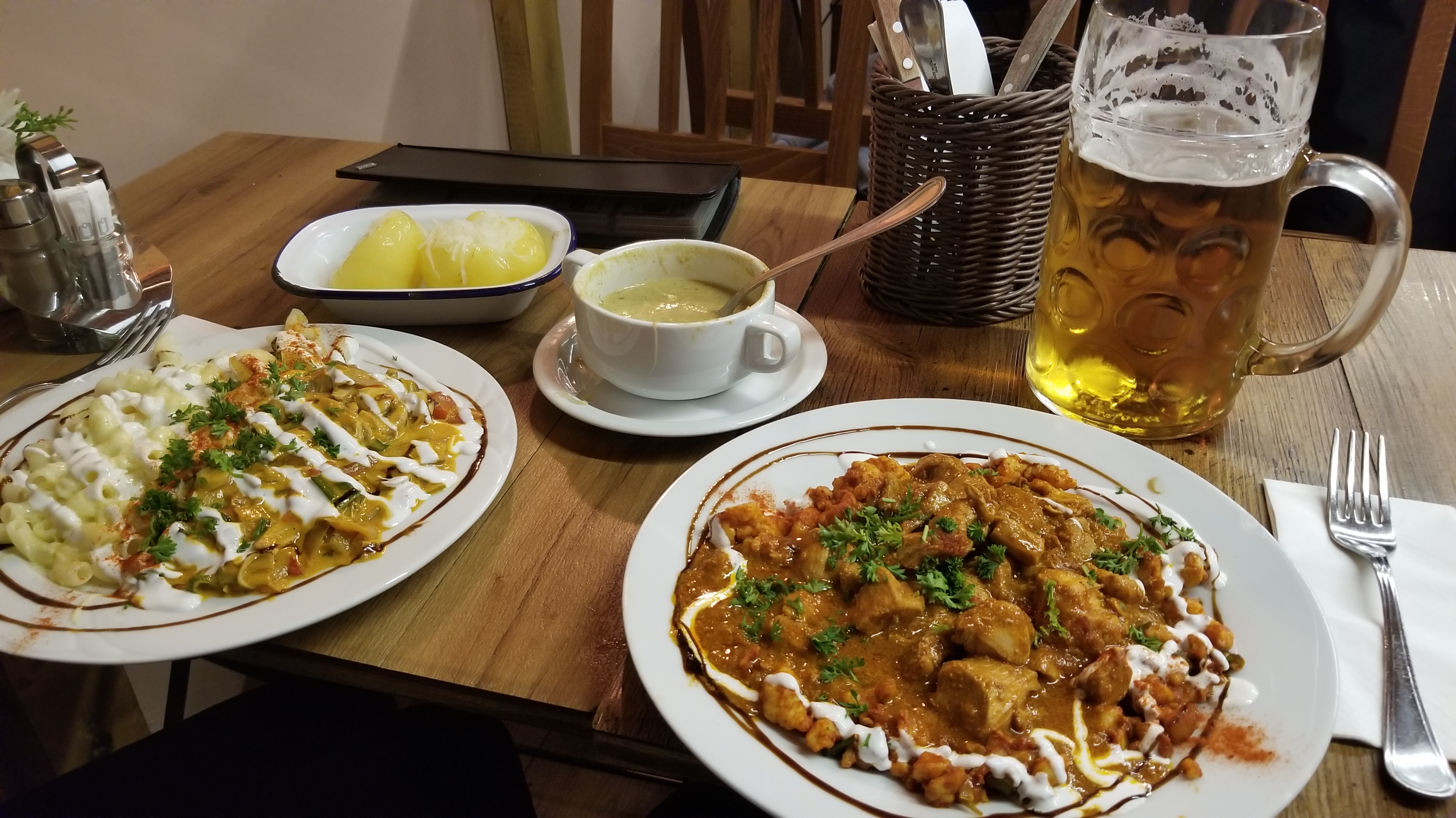 A traditional Hungarian meal (goulash and chicken paprikash with stuffed peppers and a Hungarian beer). Total cost was $14.