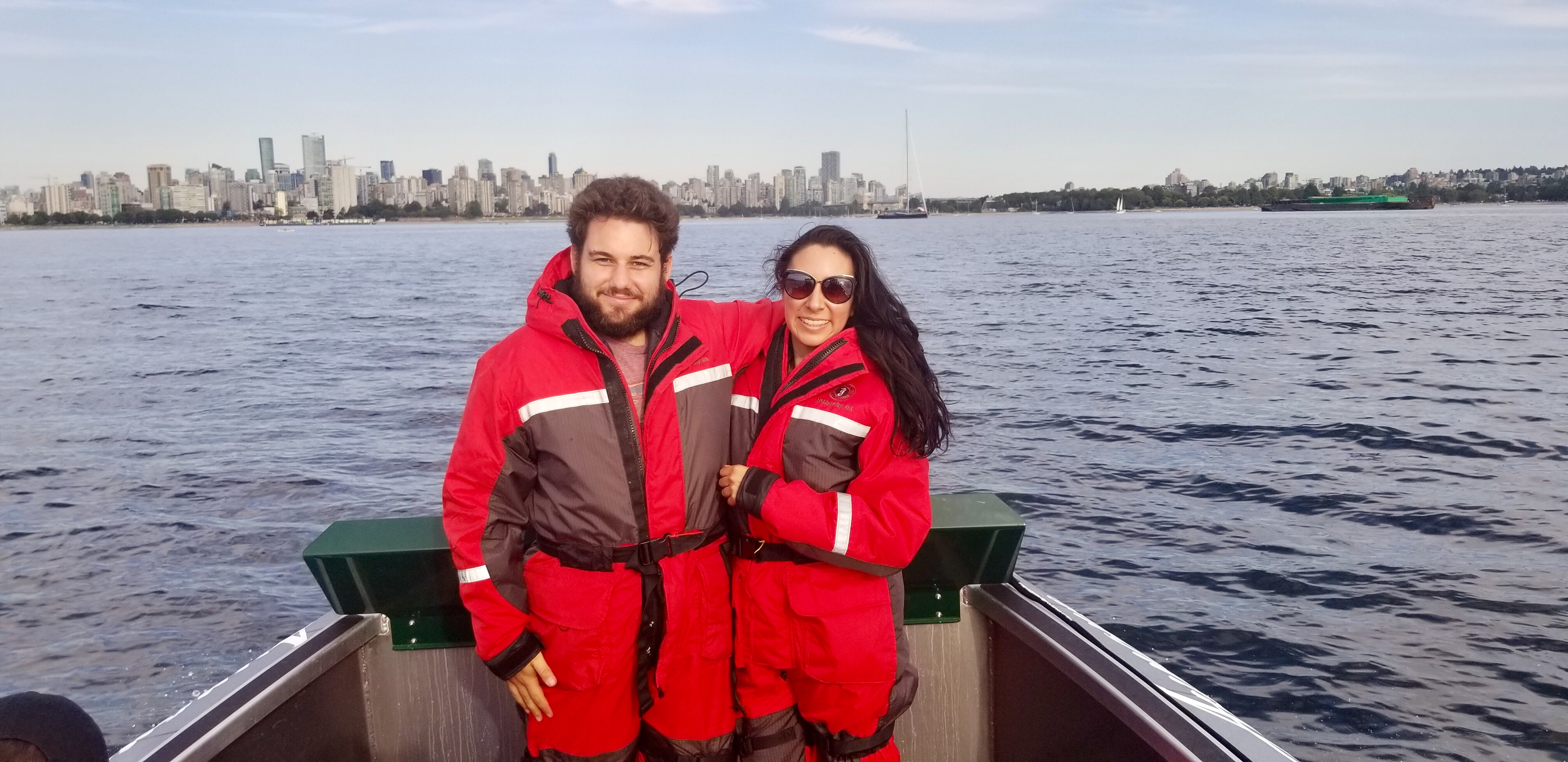 Marshmallow suits that double as flotation devices in case we flew off the whale watching boat. Vancouver skyline in background