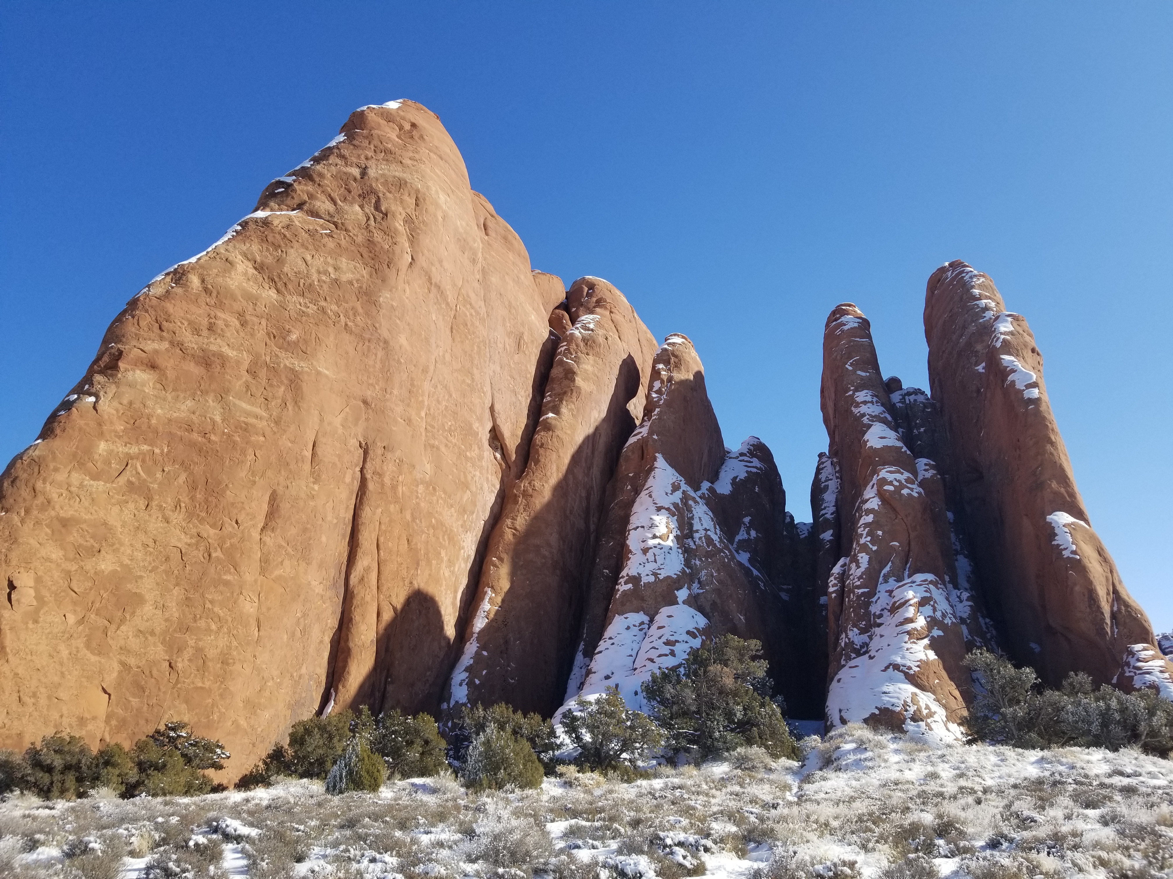 Sandstone fins in Arches National Park, Utah. These are formed when water wears grooves into sandstone blocks. Eventually, the water wears through the sides at the bottom of the fins, forming arches.