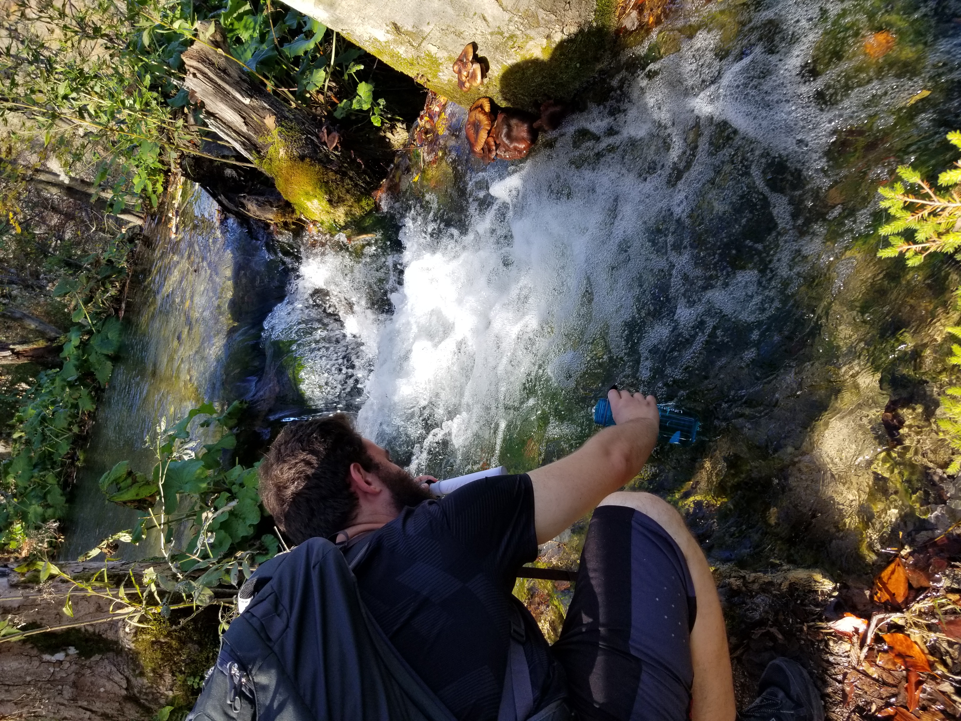 Josh refills the water bottle from a stream in Plitvice Lakes National Park in Croatia