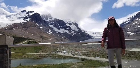 Zelzah posing in front of the view we had at breakfast at Icefield Center in Jasper NP. Not shown are the half hour line for food and sad $8/ slice pizza.