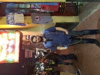 Walking down Bourbon street (party street with multiple restaurants and bars) Josh got Mardi Gras beads thrown at him