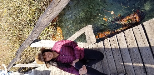 Zelzah poses next to hopeful fish in Plitvice Lakes National Park in Croatia