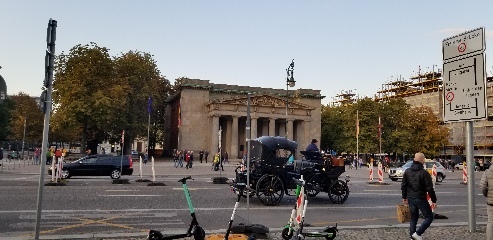 An old car just casually driving by in Berlin