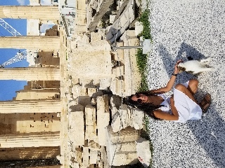 Petting a kitty outside the Parthenon which was destroyed when the Persians invaded in Athens (to clarify, the Parthenon was destroyed when the Persians invaded, not the kitty)